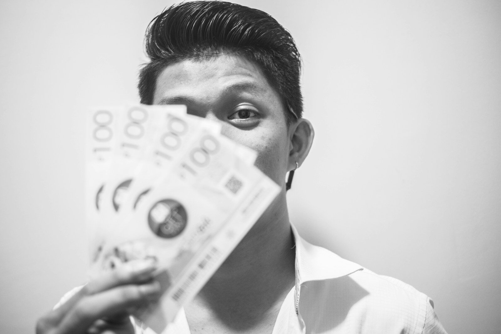 man holding peso bills